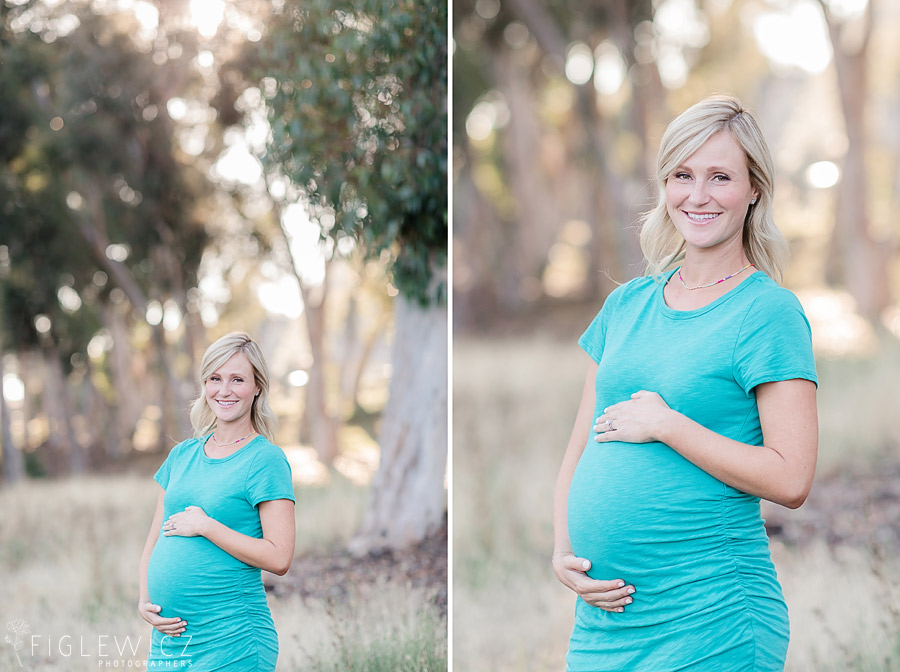 mother standing in palos verdes holding tummy in bright blue dress