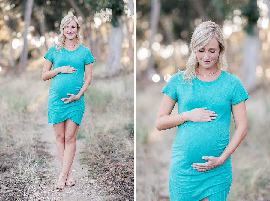 mother holding tummy in bright blue dress