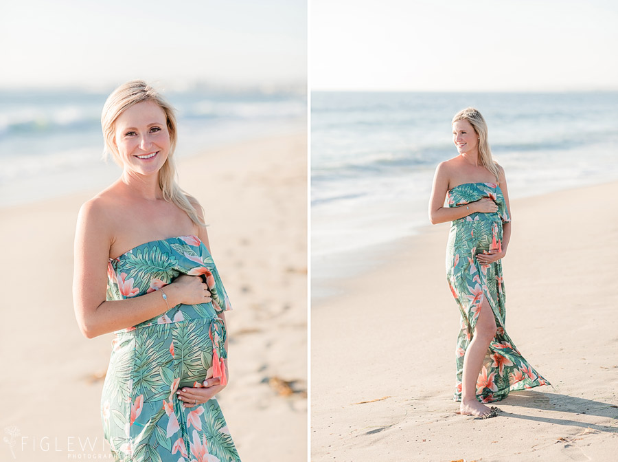 mother walking along beach holding tummy