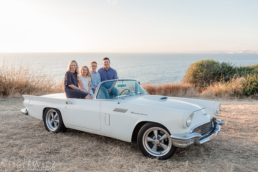 Family sitting in backseat of vintage car in Palos Verdes