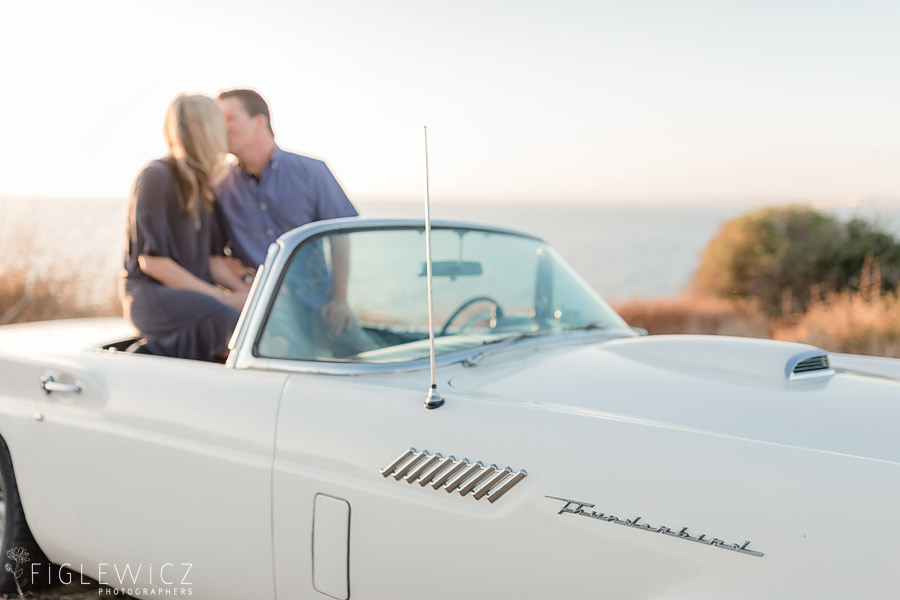 Couple kissing in car on cliffs of Palos Verdes