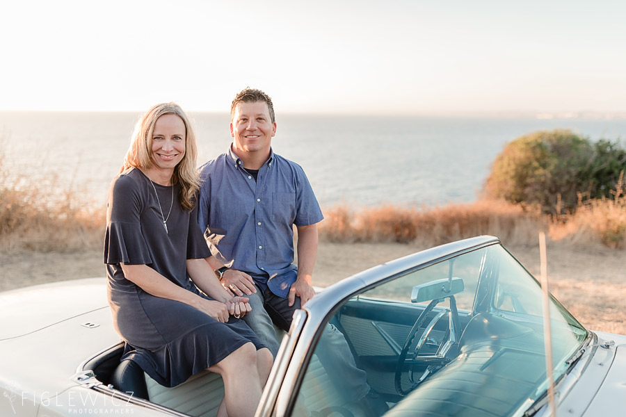 Couple smiling at camera in Ford Thunderbird during their Palos Verdes Engagement