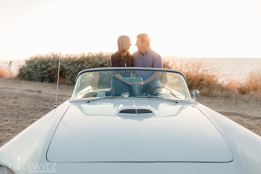 Couple sitting in Ford Thunderbird with ocean in background for Palos Verdes Engagement