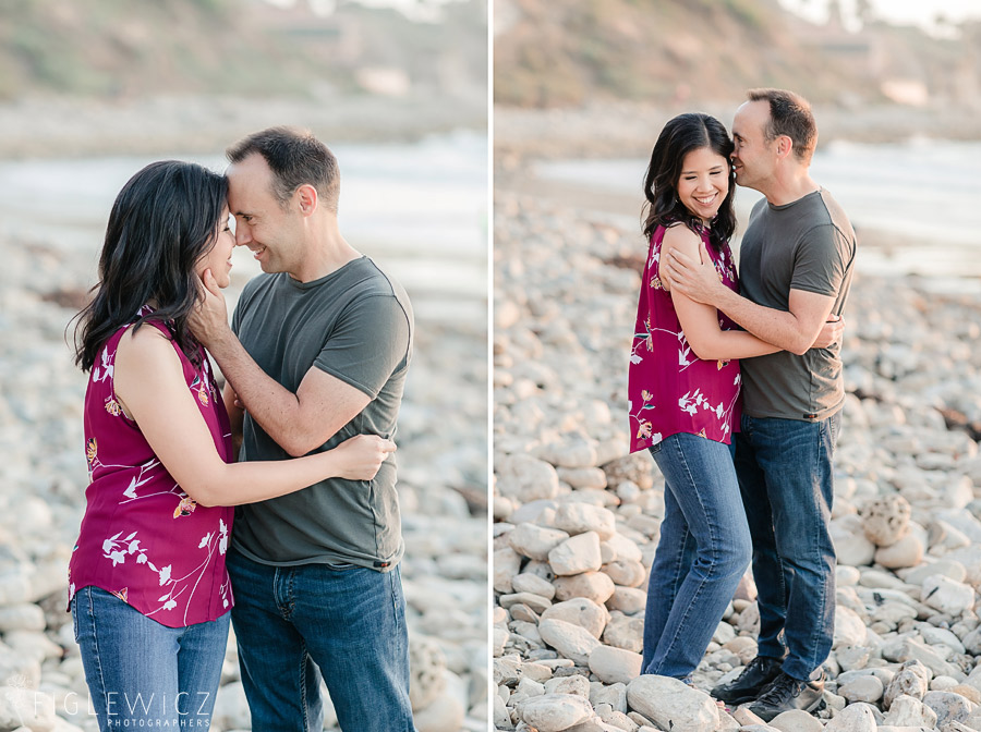 engaged couple embracing on the beach