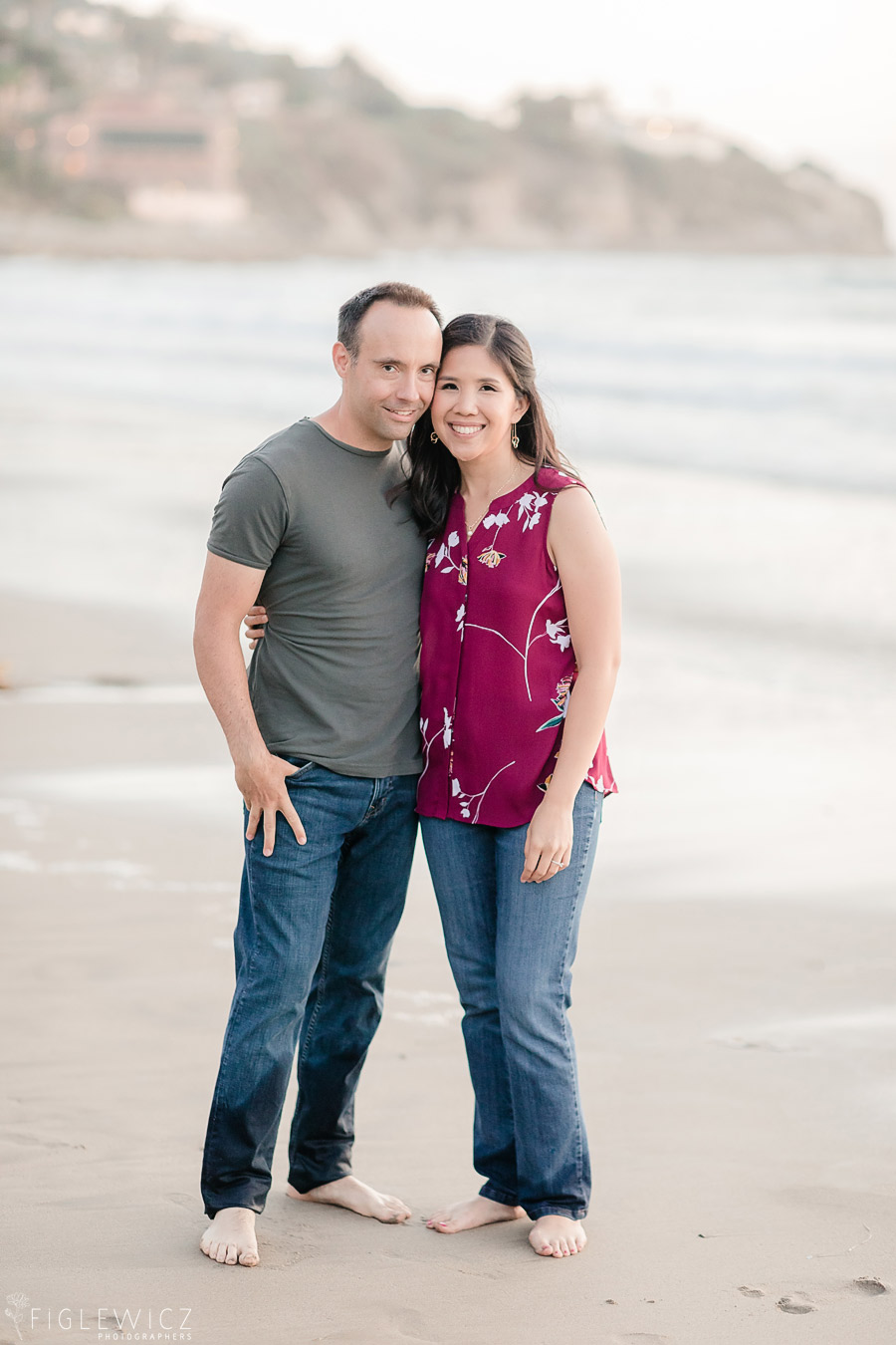 engaged couple embracing on the beach